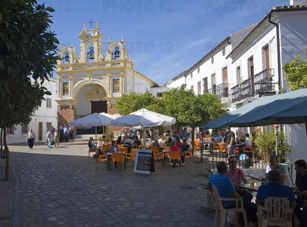 People gather in cafes and by the baroque church of San Juan at Zahara de la Sierra, Spain Sunday