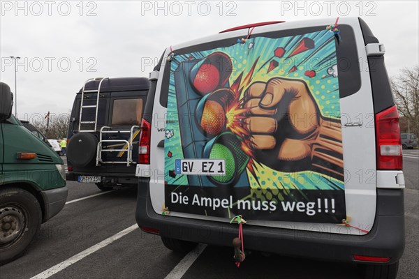 Fist smashes the traffic light, placard on a van, farmers' protests, demonstration against policies