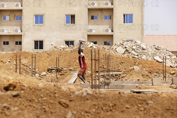 Young men working on a construction site in Nigeria, 06.02.2024
