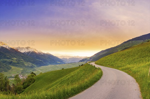 Mountain panorama of a small road in the South Tyrolean Alps, sunset, evening mood, path, Goldrain,