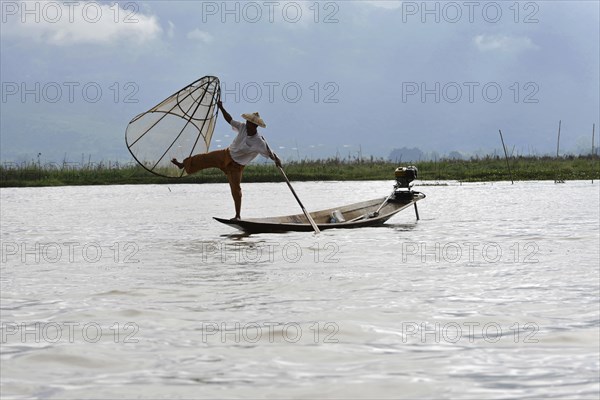 Intha fisherman, local man fishing with traditional conical fishing net, Inle Lake, Burma, Myanmar,