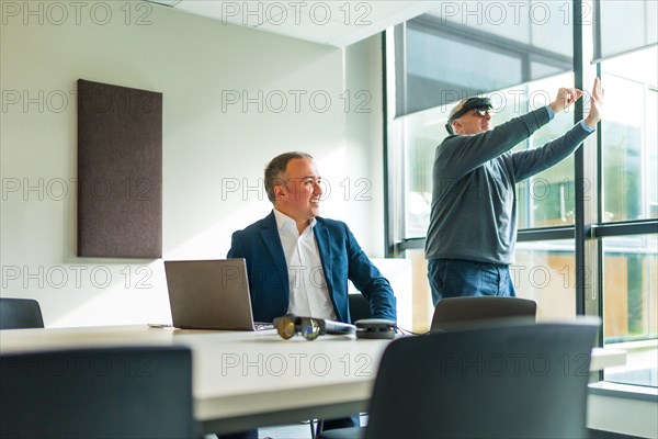 Businessmen wearing smart virtual glasses and joining business meeting on augmented reality