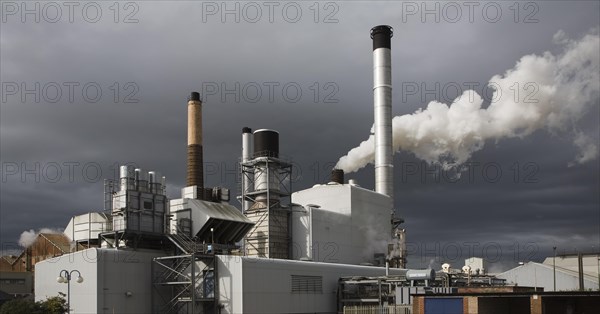 Steam rising from chimneys as sugar beet is processed at the British Sugar factory, Bury St