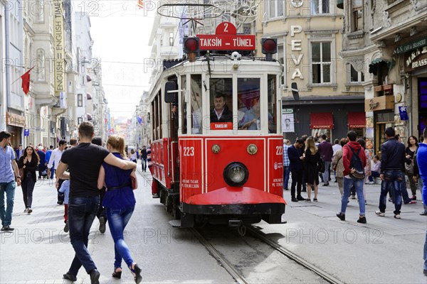 Historic tram Nostaljik Tramvay travelling through Istiklal Caddesi shopping street, Beyoglu,