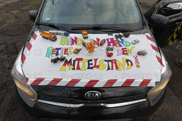 Placard with the theme Mittelstand on a car, farmers' protests, demonstration against the policy of
