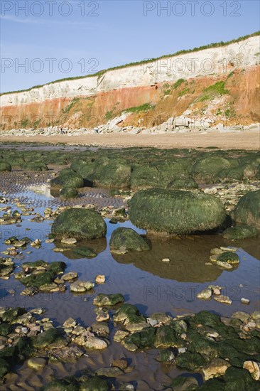Chalk, red chalk and carstone form striped cliffs of white, red and orange at Hunstanton, Norfolk,
