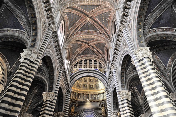 Black and white striped marble columns in the cathedral, cross and round arches, Siena, Tuscany,