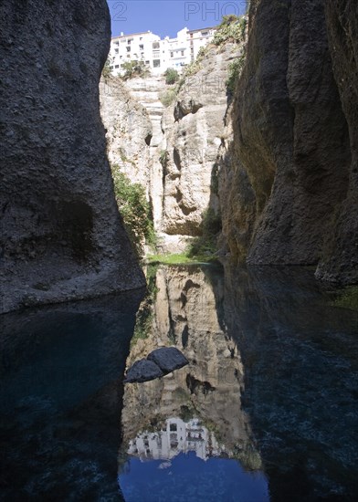 El Tajo canyon of the Rio Guadalevin river with white buildings perched on the cliff top, Ronda,
