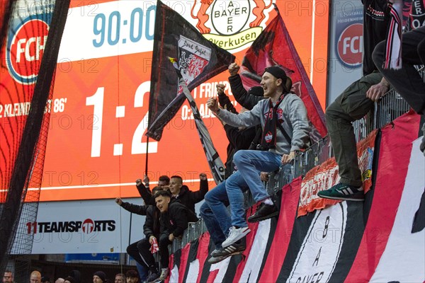 Football match, Bayer Leverkusen fans celebrate the victory of their team in Heidenheim together