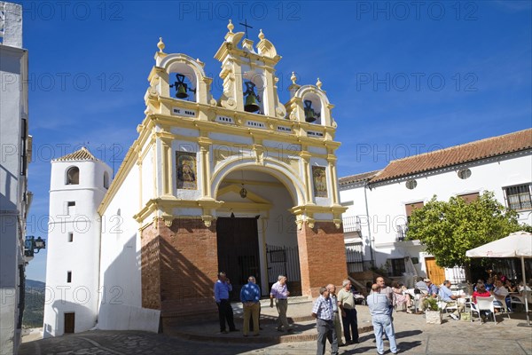 People gather by the baroque church of San Juan at Zahara de la Sierra, Spain Sunday 13 October
