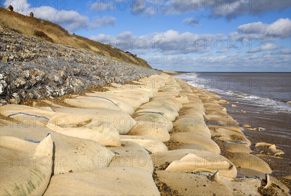 Coastal defences normally covered by shingle exposed by winter storms at Thorpeness, Suffolk,