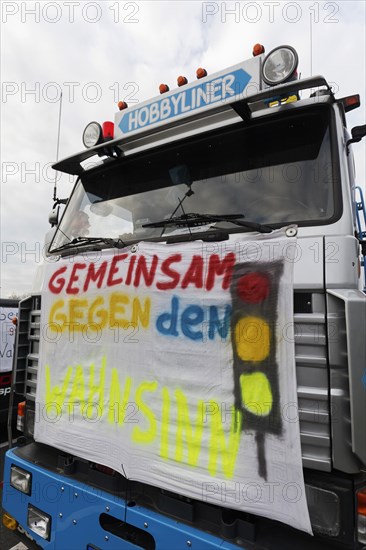 Together against the madness of traffic lights, banner on a truck, farmers' protests, demonstration