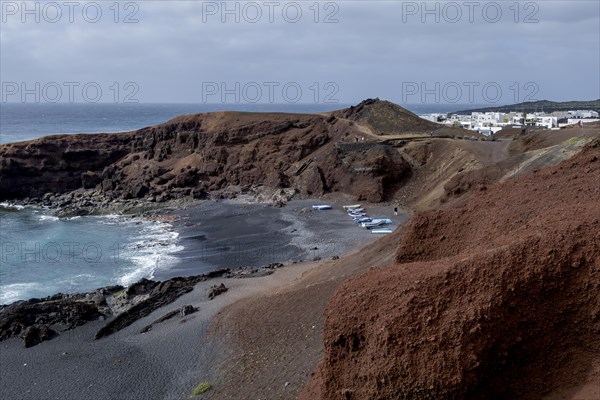 Fishing boats on the black beach of El Golfo, volcanic crater, Lanzarote, Canary Islands, Spain,