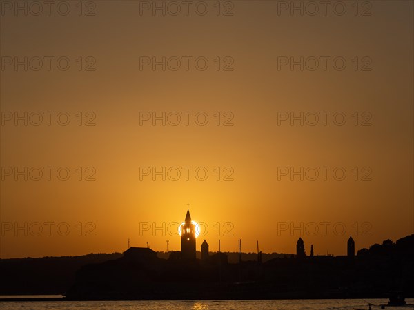 Sunset, silhouette of the church towers of Rab, town of Rab, island of Rab, Kvarner Gulf Bay,