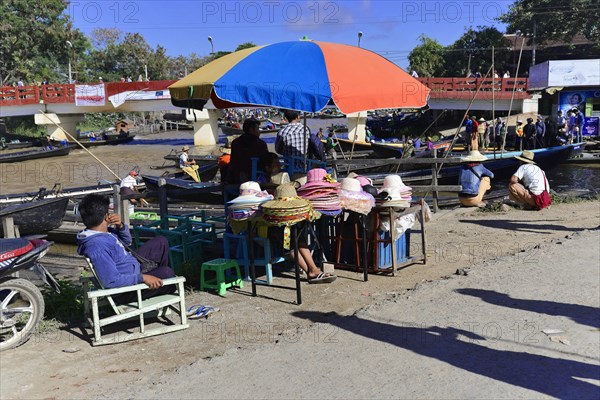 Colourful scene of a riverside street market with boats and people, Pindaya, Inle Lake, Myanmar,