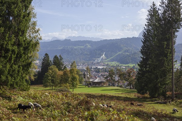 Overview of Garmisch-Partenkirchen with Karwendel mountains and forest in autumn, hiking trail