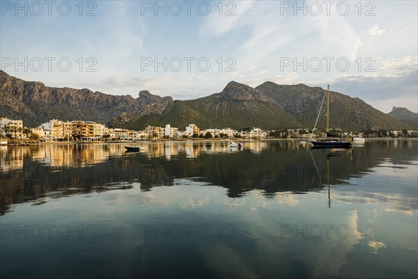 Village by the sea and mountains at sunrise, Port de Pollenca, Serra de Tramuntana, Majorca,