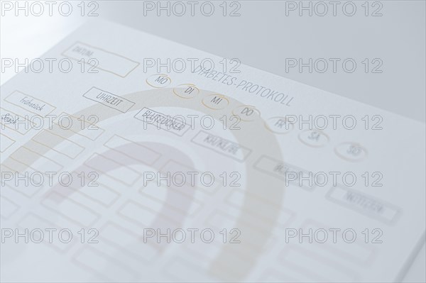 Diabetes log, daily log of food and insulin administration, food log, the paper lies on a white