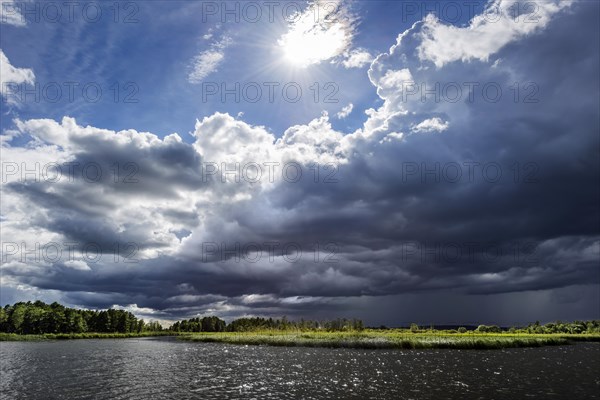 Dramatic changeable weather on the lake with cloudy sky, sun, cloud, light, light mood, atmosphere,
