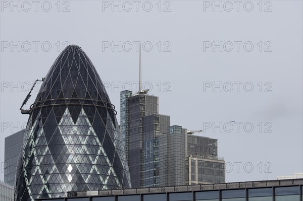 The Gherkin skyscraper building and nearby high rise office building, City of London, England,
