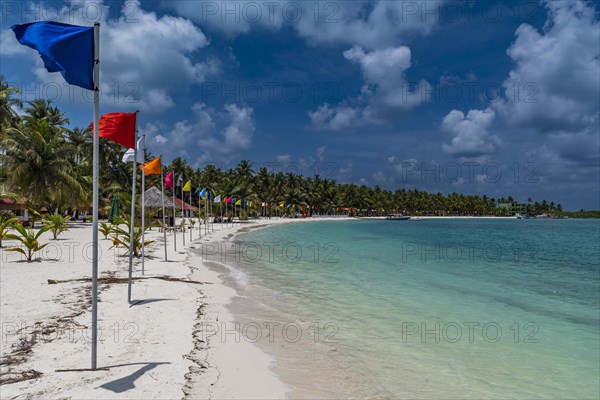 White sand beach with many flags, Bangaram island, Lakshadweep archipelago, Union territory of