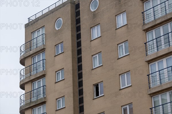 A section of a cream-coloured residential building with balconies, Blankenberge, Flanders, Belgium,