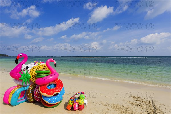 Sale of inflatable swimming aids, colourful, swimming, beach vendor, holiday, symbol, symbolic,