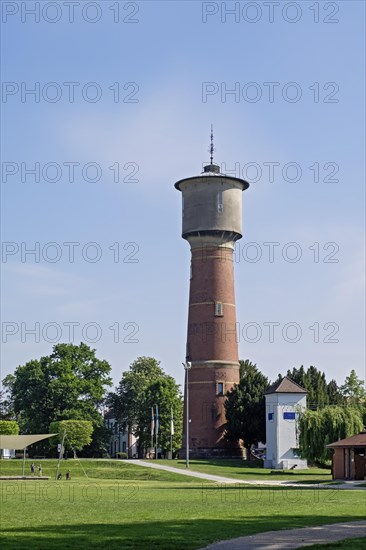 Brick water tower stands on a green lawn under a clear blue sky, Ladenburg, Baden-Wuerttemberg,