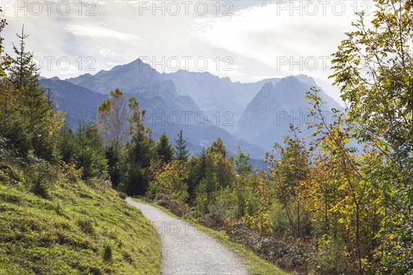 Wetterstein mountains with Alpspitze, Zugspitze massif and houses with hiking trail Philosophenweg,
