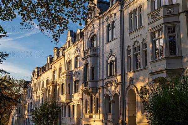 The sun illuminates old building facades in the morning light, Wilhelminian style, Briller Viertel,