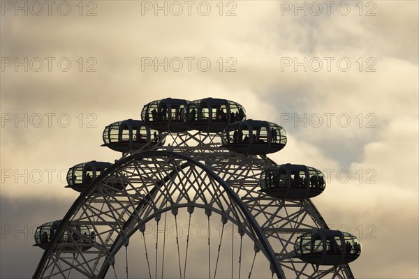 London Eye or Millennium Wheel tourist observation wheel close up of pods at sunset, City of