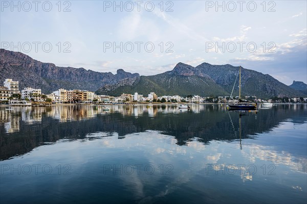 Village by the sea and mountains at sunrise, Port de Pollenca, Serra de Tramuntana, Majorca,