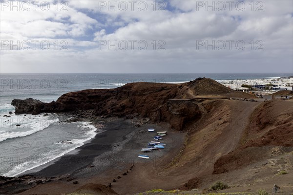 Fishing boats on the black beach of El Golfo, volcanic crater, Lanzarote, Canary Islands, Spain,