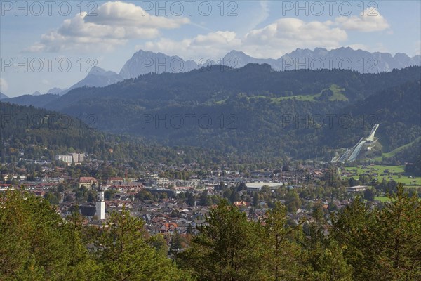 Overview of Garmisch-Partenkirchen with Karwendel mountains and forest in autumn, hiking trail