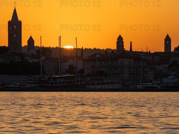 Sunset, silhouette of the church towers of Rab, town of Rab, island of Rab, Kvarner Gulf Bay,