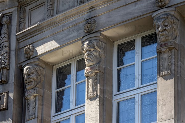 Allegorical reliefs, heads for wit, malice, mockery, Giessen City Theatre by architects Fellner &