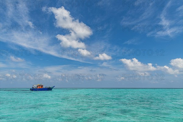 Little boat in the turquoise waters of Agatti Island, Lakshadweep archipelago, Union territory of