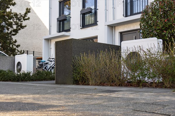 Two heat pumps in the front garden of terraced houses in Duesseldorf, North Rhine-Westphalia,