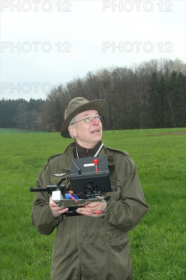 Hunter observes and controls flying drone during a hare (Lepus europaeus) census, Lower Austria,