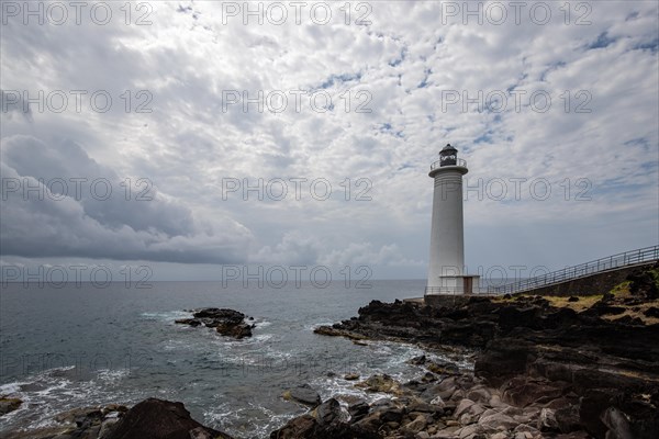 White lighthouse on a steep coast. Dramatic clouds with a view of the sea, pure Caribbean at Le