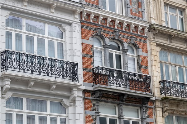 Detailed view of a classically designed brick facade with white window frames, Blankenberge,