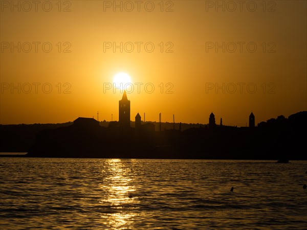 Sunset, silhouette of the church towers of Rab, town of Rab, island of Rab, Kvarner Gulf Bay,