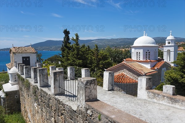 View of churches and the sea, surrounded by a stone wall and red roofs, Byzantine fortress with