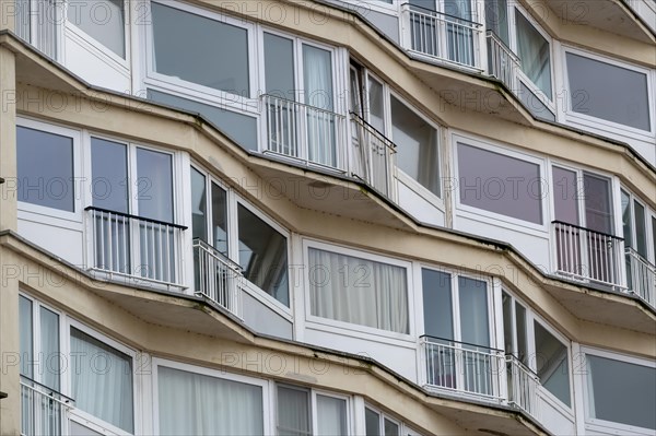 Curved residential building with curved balconies and reflective windows, Blankenberge, Flanders,