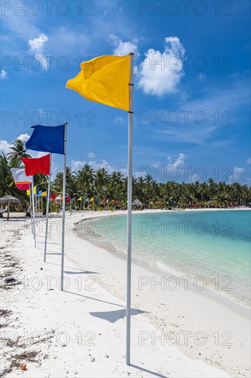 White sand beach with many flags, Bangaram island, Lakshadweep archipelago, Union territory of