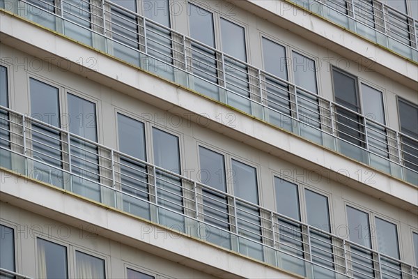 Symmetrical view of residential balconies with glass railings and white frames, Blankenberge,