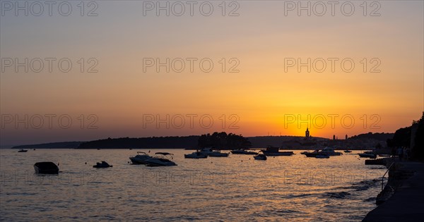 Sunset, boats anchoring in a bay near Rab, panoramic view, town of Rab, island of Rab, Kvarner Gulf