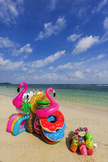 Sale of inflatable swimming aids, colourful, swimming, beach vendor, holiday, symbol, symbolic,