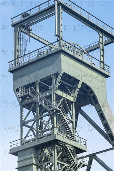 Mighty steel construction of an industrial winding tower against a blue sky, Oberhausen, North