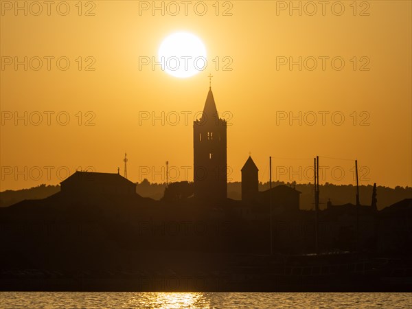 Golden evening light at sunset, silhouette of the church towers of Rab, town of Rab, island of Rab,